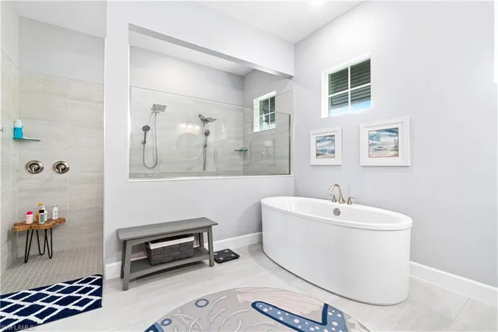 Bathroom featuring tile patterned floors and a tile shower