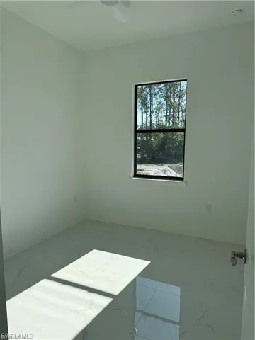 Spare room with ceiling fan