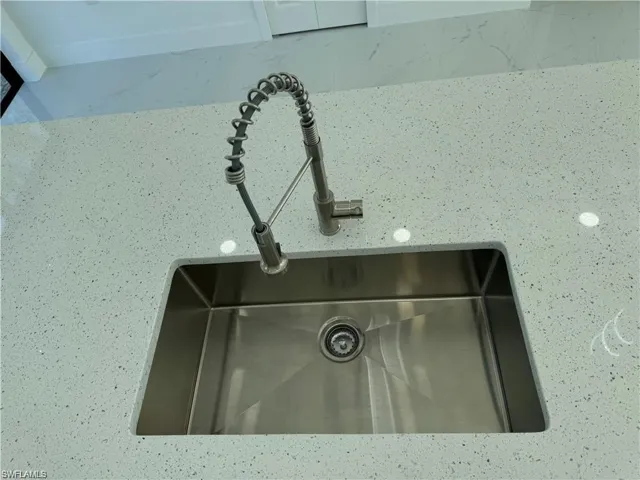 Details featuring light stone counters and sink