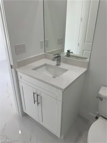 Bathroom featuring vanity and toilet