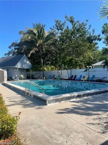 View of swimming pool with an outdoor structure and a patio area