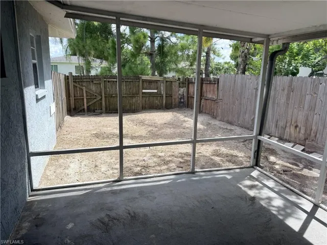 Screened patio with a concrete floor and direct access to a fenced backyard
