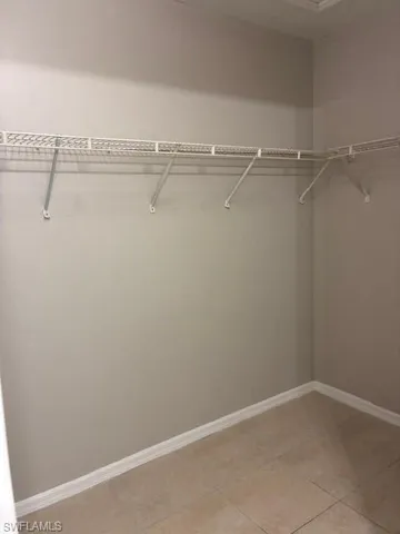 Walk in closet with light tile patterned flooring
