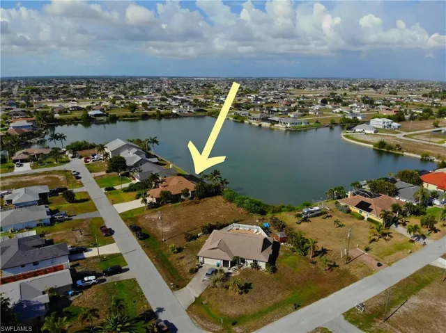 Aerial view of residential area featuring a nearby body of water