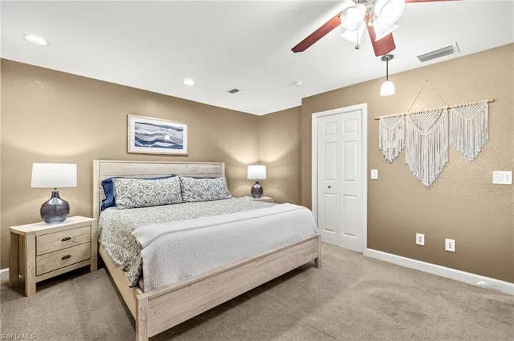 Carpeted bedroom featuring baseboards, a ceiling fan, and recessed lighting