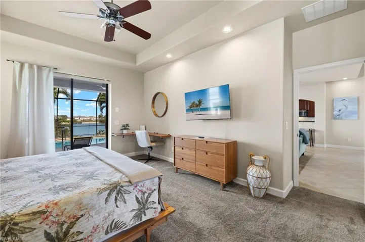 Bedroom featuring access to outside, recessed lighting, light carpet, baseboards, and a desk
