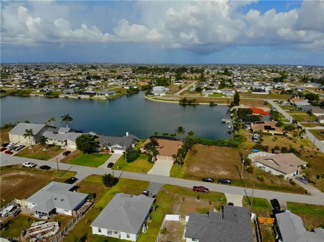 Aerial view of residential area featuring a large body of water