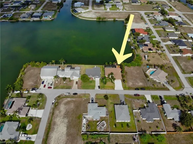 Aerial view of property's location with nearby suburban area and a nearby body of water