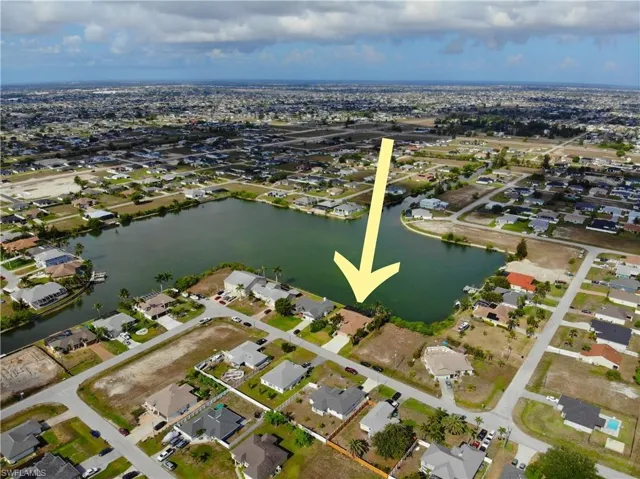 Aerial overview of property's location with nearby suburban area and a nearby body of water