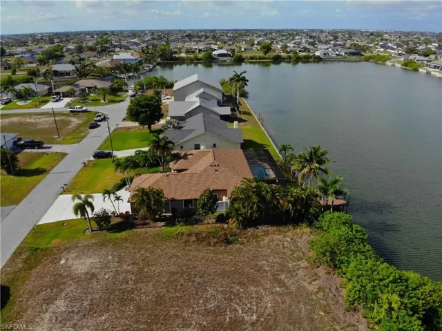 Aerial perspective of suburban area featuring a nearby body of water