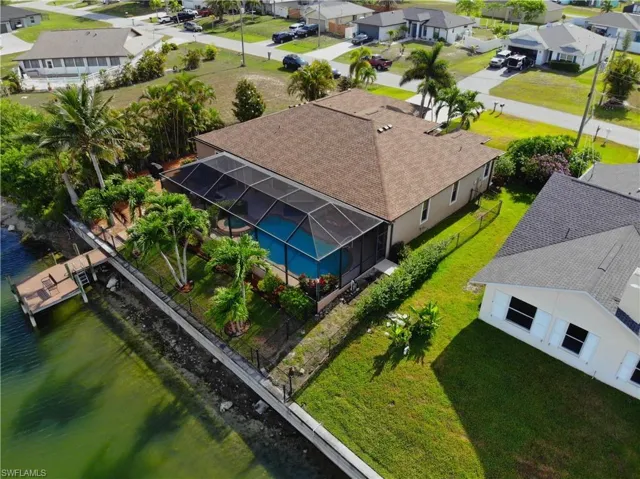Aerial view of residential area featuring a large body of water