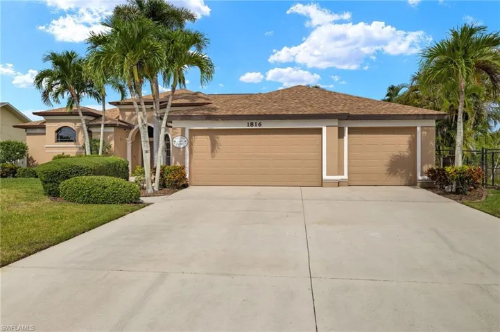 Single story home featuring an attached garage, concrete driveway, and stucco siding
