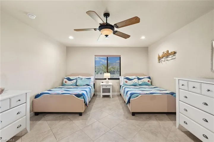 Bedroom featuring ceiling fan, recessed lighting, baseboards, and light tile patterned flooring