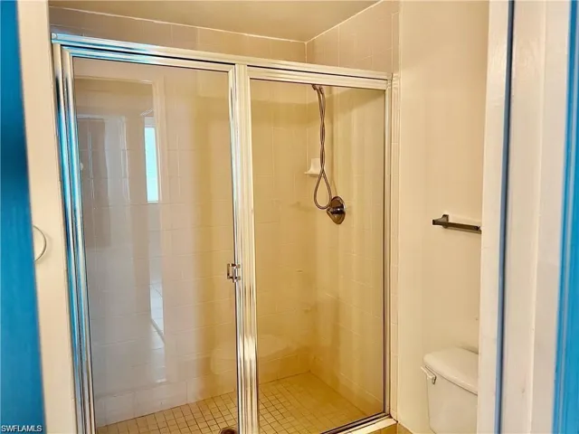 Full bath featuring a shower stall