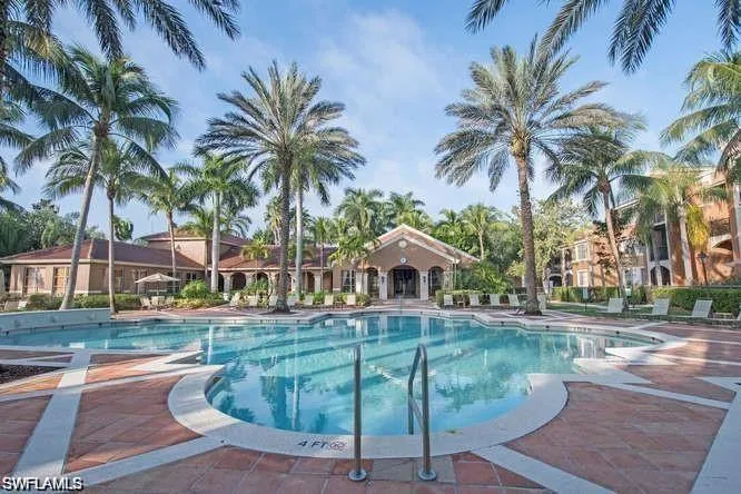 Community pool with a patio
