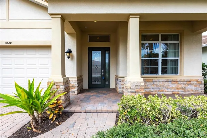 Property entrance featuring stone siding and stucco siding