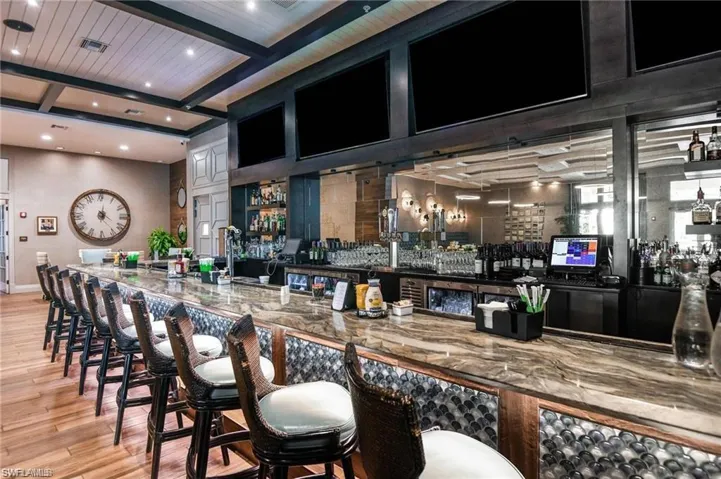 Bar with light wood-style flooring, recessed lighting, visible vents, beam ceiling, at the River House