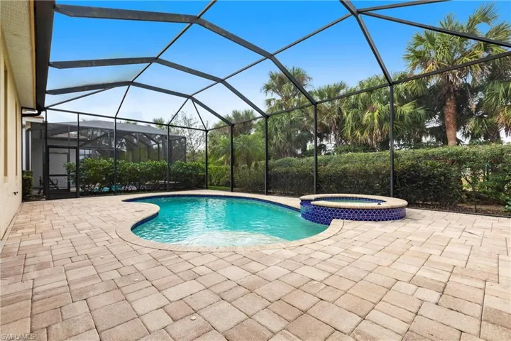 View of pool/spa with screen enclosure in lanai