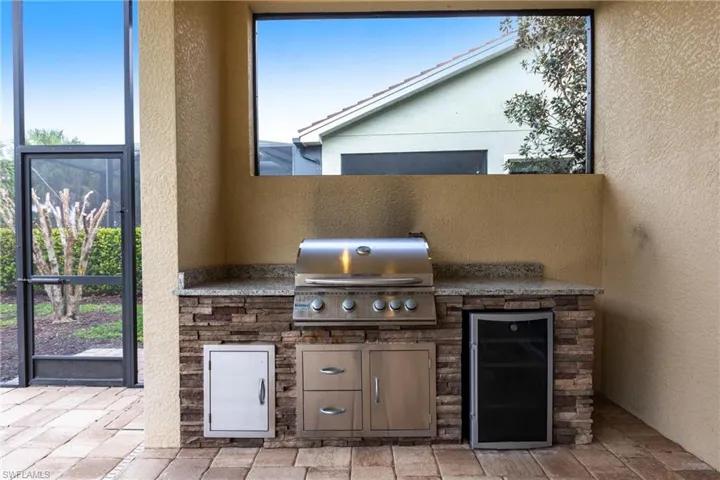 View of patio featuring area for grilling