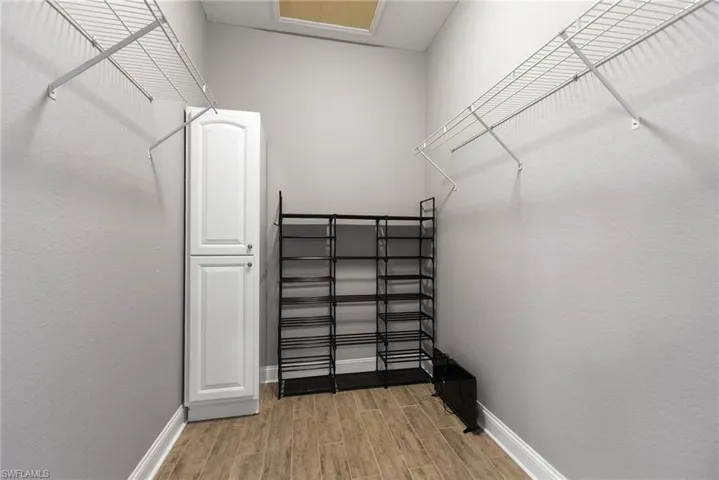 Spacious closet featuring hardwood / wood-style floors