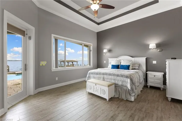 Bedroom featuring crown molding, hardwood / wood-style flooring, ceiling fan, and access to exterior