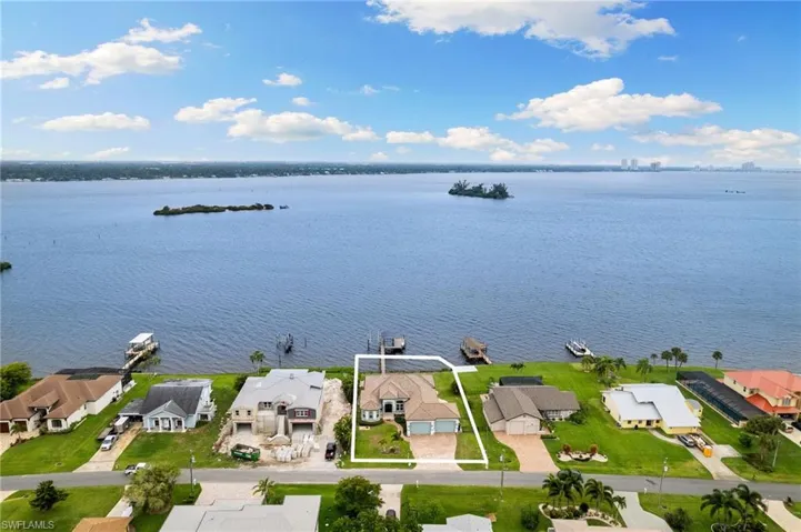 Birds eye view of property with a water view