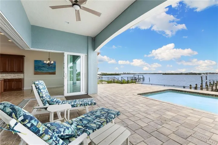 View of terrace featuring ceiling fan and a water view