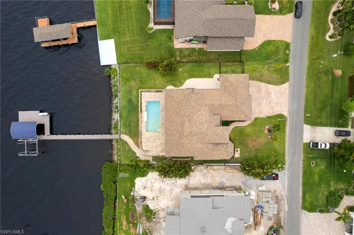 Birds eye view of property with a water view