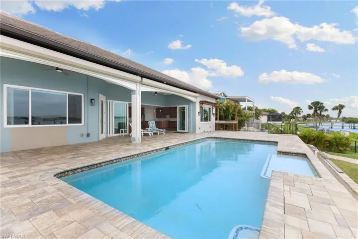 View of pool featuring a patio area and ceiling fan