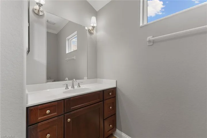 Bathroom with vanity and ornamental molding