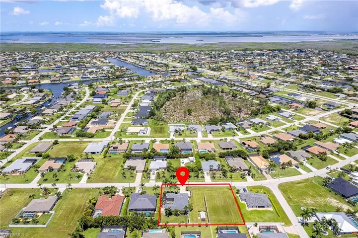 Birds eye view of property with a water view