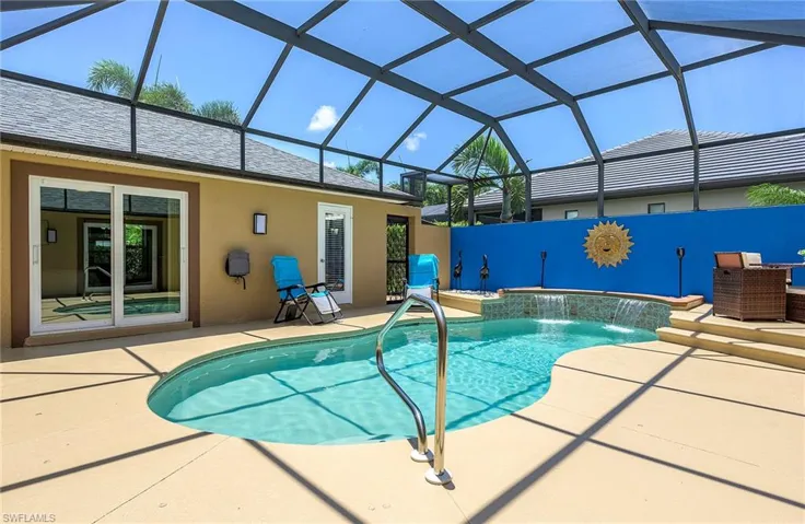View of pool featuring pool water feature, a patio area, and a lanai