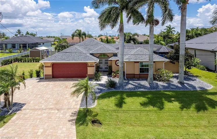 View of front of home with a garage and a front yard