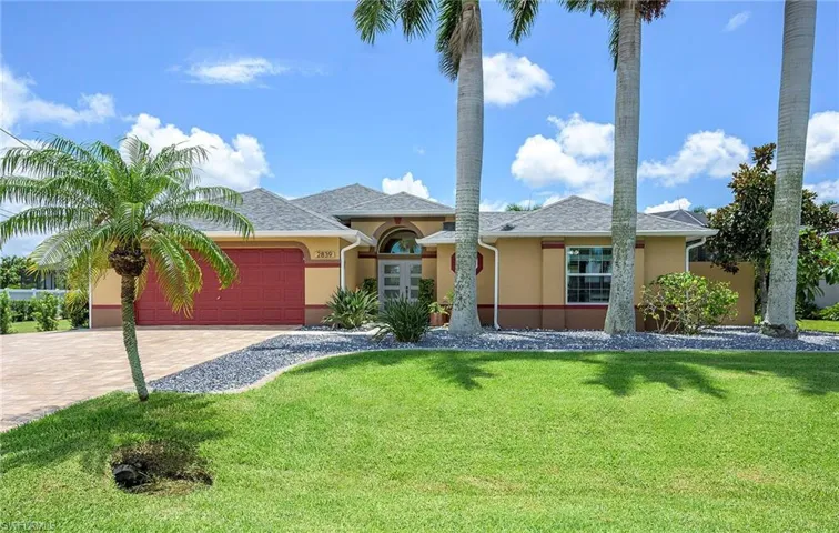View of front of property with a garage and a front yard