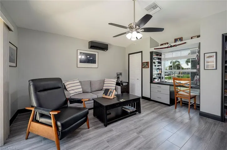 Living room with wood-type flooring and ceiling fan
