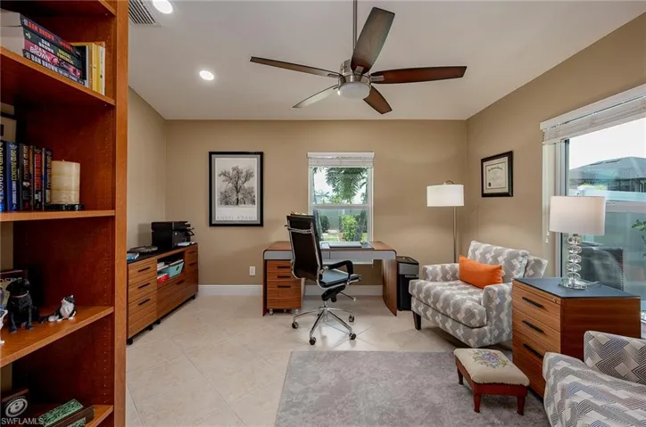 Tiled home office featuring ceiling fan