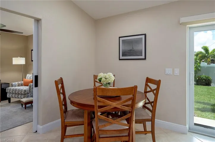 Dining area with light tile patterned flooring and a wealth of natural light