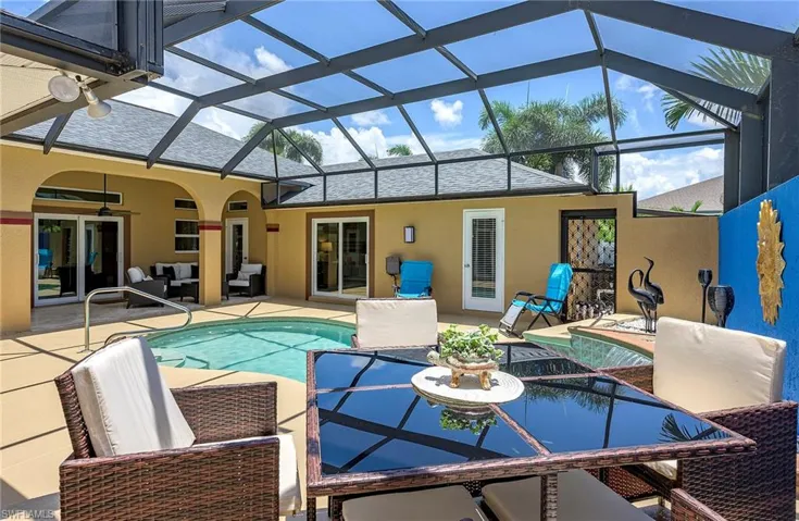 View of swimming pool with a patio area, ceiling fan, french doors, and glass enclosure