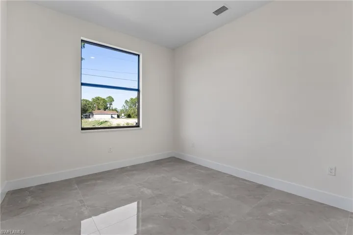Empty room featuring baseboards and light marble finish flooring