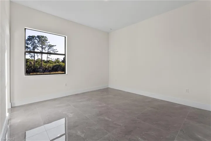 Empty room featuring light marble finish floors