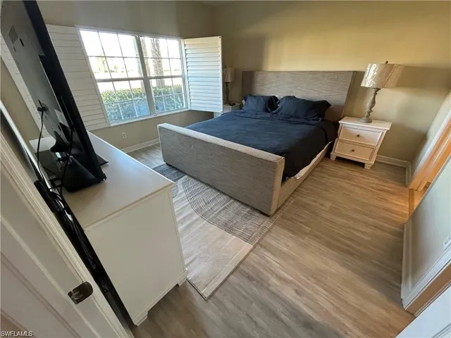 Bedroom featuring wood finished floors and baseboards