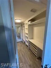 Walk in closet featuring dark wood-style flooring