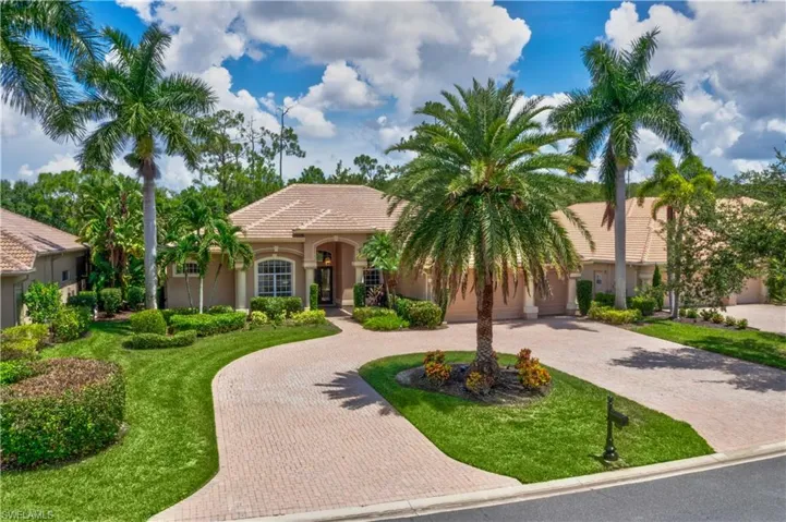 Mediterranean / spanish house with a garage and a front lawn
