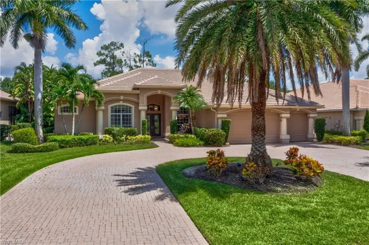 Mediterranean / spanish-style house featuring a garage and a front yard