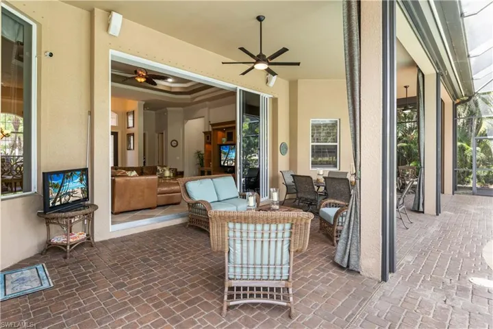 View of patio with outdoor lounge area and ceiling fan