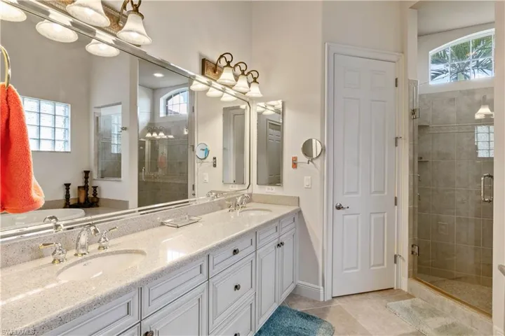 Bathroom with separate shower and tub, a wealth of natural light, and double vanity