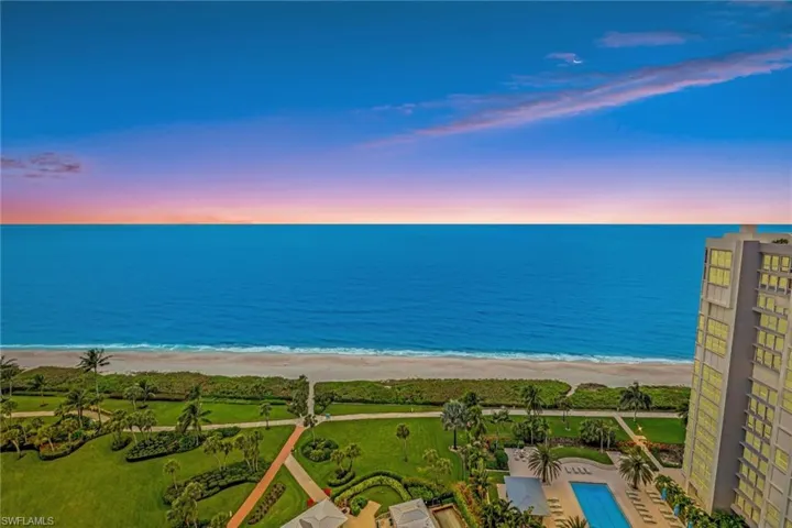 Aerial view at dusk with a water view and a beach view - from building Sundeck