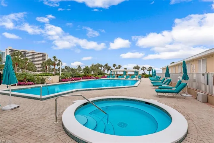View of pool featuring a community hot tub and a patio
