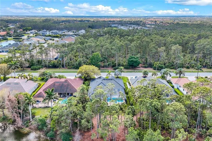 Aerial view with a wooded view and a residential view