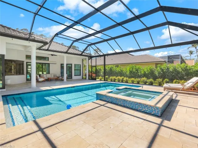 View of pool with a ceiling fan, a patio, glass enclosure, an outdoor hangout area, and a pool with connected hot tub